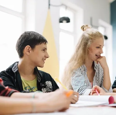 11 plus students sitting round the table and studying in Surrey.